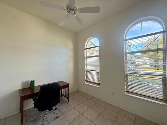 office with ceiling fan, light tile patterned floors, and baseboards