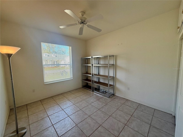 unfurnished room featuring ceiling fan and light tile patterned floors