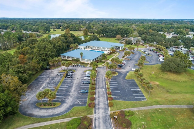 drone / aerial view featuring a wooded view