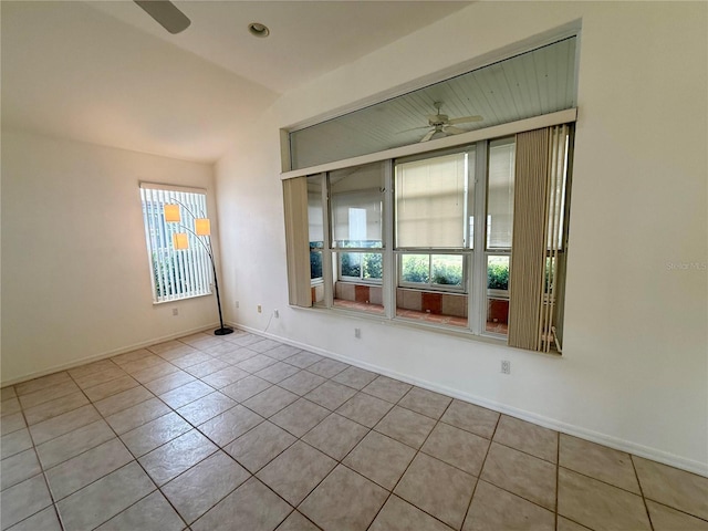 6688 SW 113th Pl, Ocala, FL 34476 - empty room with ceiling fan, healthy amount of natural light, tile patterned floors, lofted ceiling, and baseboards