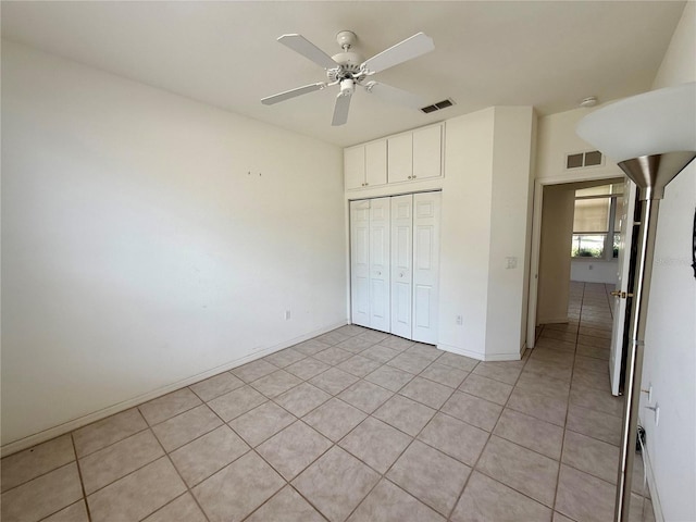 6688 SW 113th Pl, Ocala, FL 34476 - unfurnished bedroom featuring a closet, light tile patterned floors, a ceiling fan, and baseboards
