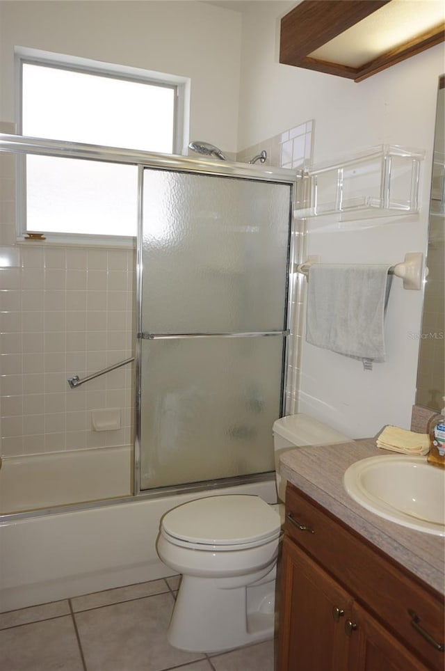 6688 SW 113th Pl, Ocala, FL 34476 - bathroom with vanity, toilet, bath / shower combo with glass door, and tile patterned flooring