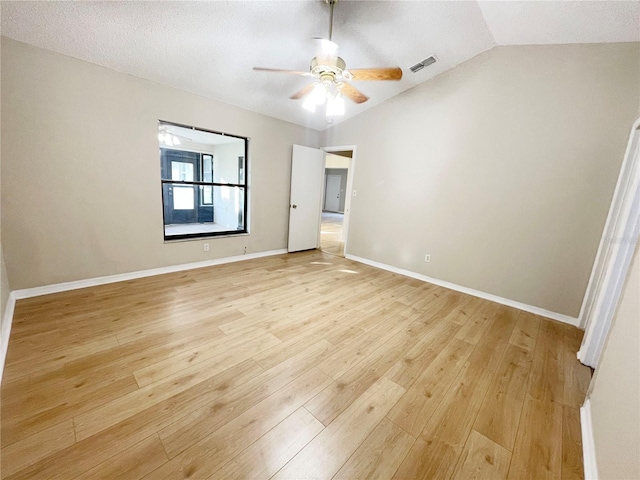 unfurnished bedroom with ceiling fan, lofted ceiling, a textured ceiling, and light hardwood / wood-style flooring