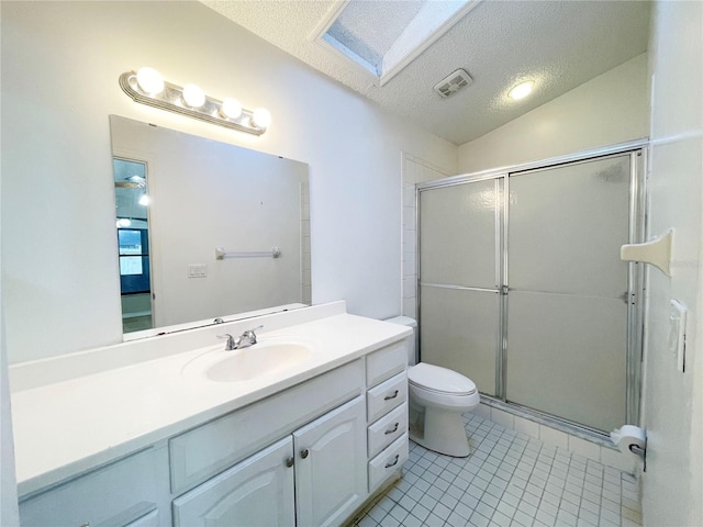 bathroom with vaulted ceiling with skylight, vanity, a shower with shower door, and a textured ceiling