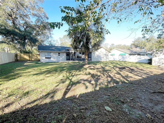 back of property featuring a lawn