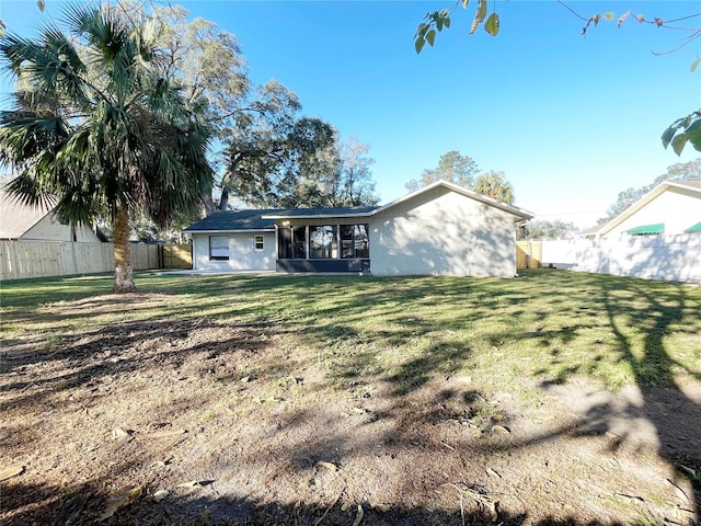 rear view of house with a yard