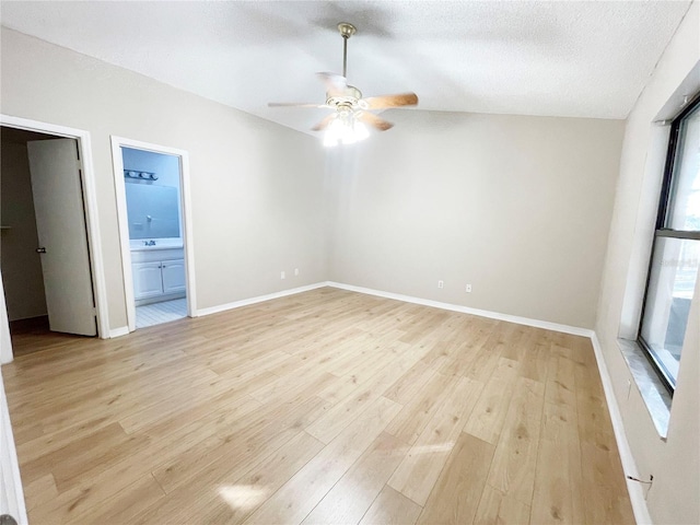 unfurnished room with ceiling fan, plenty of natural light, a textured ceiling, and light wood-type flooring