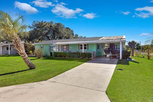 single story home with covered porch, a carport, and a front lawn