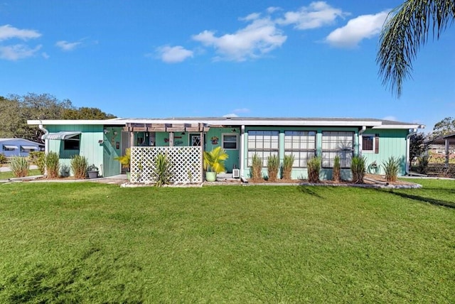 rear view of property with a yard