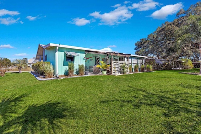 rear view of house with a yard