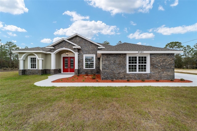 craftsman house featuring french doors and a front lawn