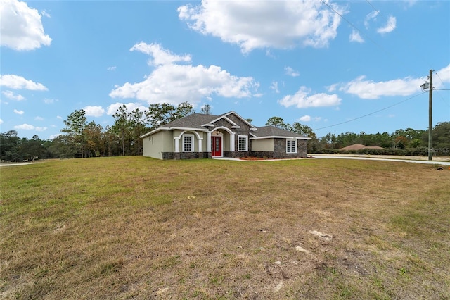 ranch-style home featuring a front lawn