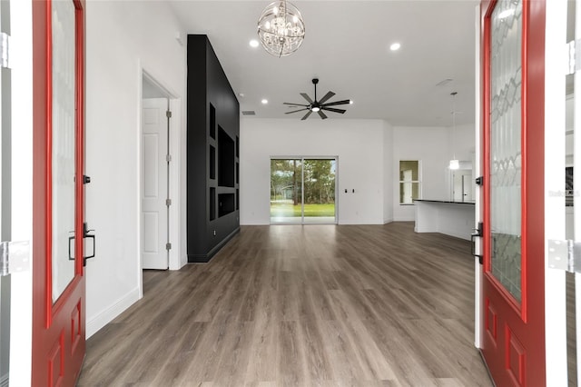 foyer entrance featuring dark hardwood / wood-style flooring and ceiling fan with notable chandelier