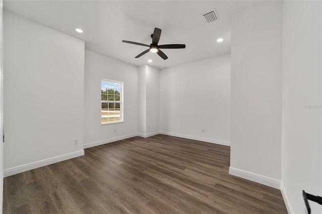 spare room with dark hardwood / wood-style floors and ceiling fan