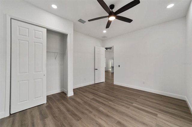 unfurnished bedroom featuring ceiling fan, a closet, and dark hardwood / wood-style floors