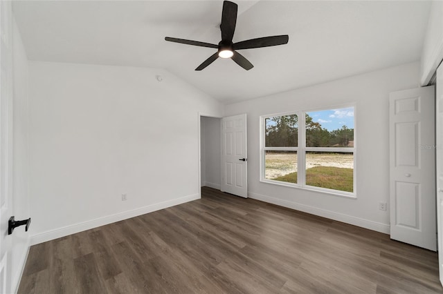 unfurnished bedroom with ceiling fan, dark hardwood / wood-style flooring, and lofted ceiling