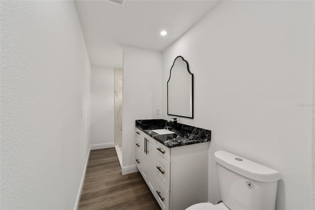 bathroom featuring hardwood / wood-style floors, vanity, and toilet