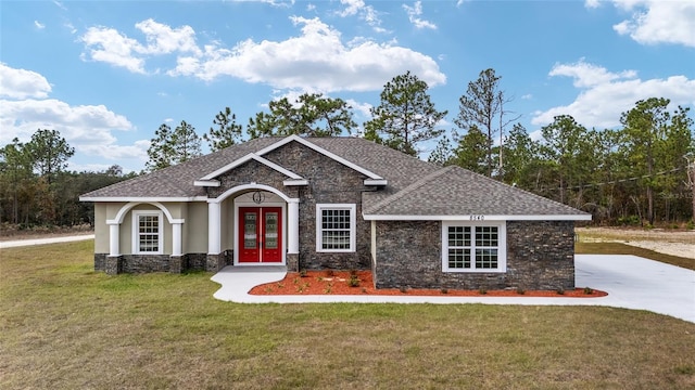 craftsman house with a front yard and french doors