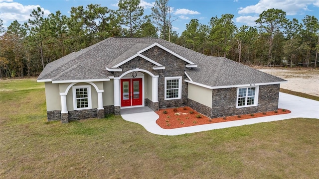 craftsman-style home featuring french doors and a front yard