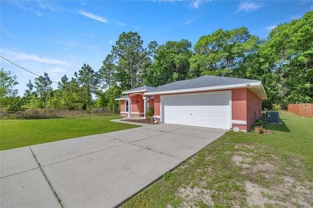 view of front facade with central air condition unit, a front yard, and a garage