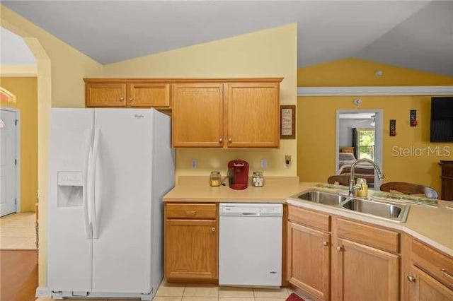 kitchen featuring sink, kitchen peninsula, lofted ceiling, white appliances, and light tile patterned floors