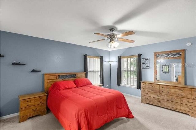 bedroom with light colored carpet and ceiling fan