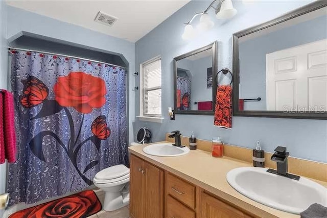 bathroom with a shower with shower curtain, vanity, and toilet