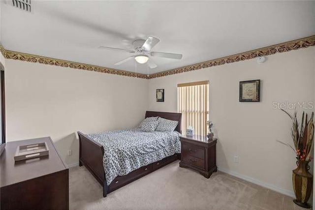 bedroom with ceiling fan and light colored carpet