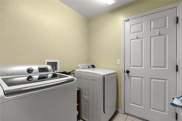 washroom featuring light tile patterned floors and separate washer and dryer