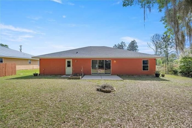 back of property featuring a yard and a patio