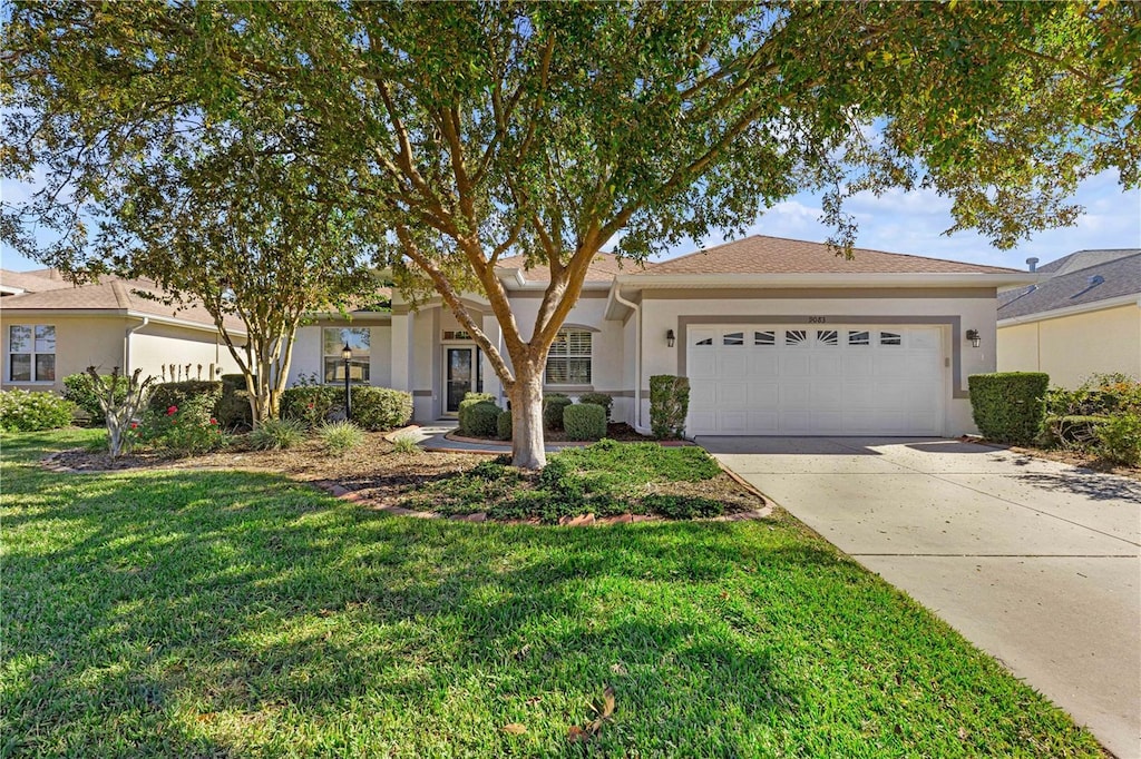 ranch-style house with a garage and a front lawn