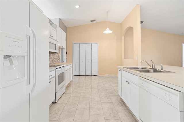 kitchen with white appliances, vaulted ceiling, sink, white cabinetry, and hanging light fixtures