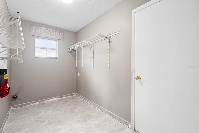 laundry room with a textured ceiling