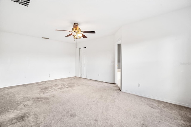 spare room with light colored carpet and ceiling fan