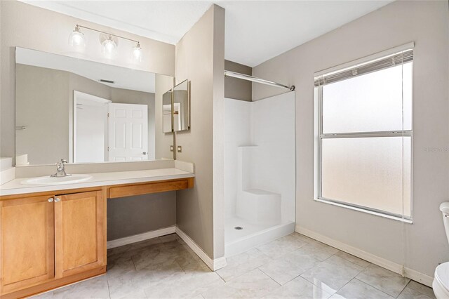 bathroom with plenty of natural light, toilet, and a shower