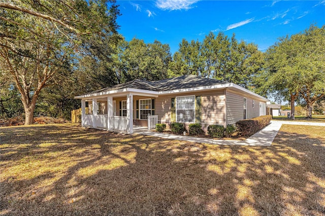 ranch-style house with covered porch and a front lawn