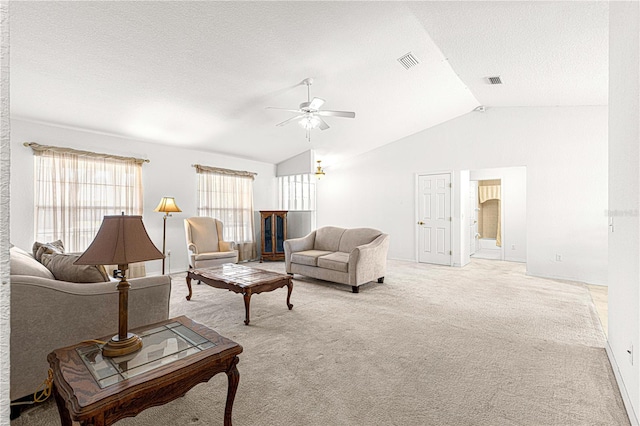 living room featuring a textured ceiling, light carpet, ceiling fan, and lofted ceiling