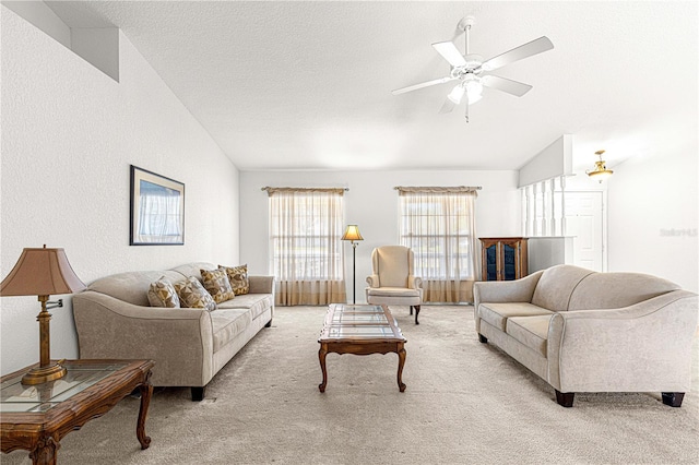 living room featuring a textured ceiling, light colored carpet, and lofted ceiling