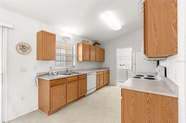 kitchen featuring sink, independent washer and dryer, vaulted ceiling, a textured ceiling, and white appliances