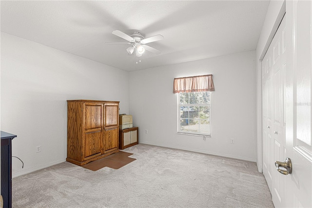 carpeted bedroom with a closet and ceiling fan