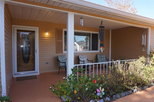 view of exterior entry with covered porch