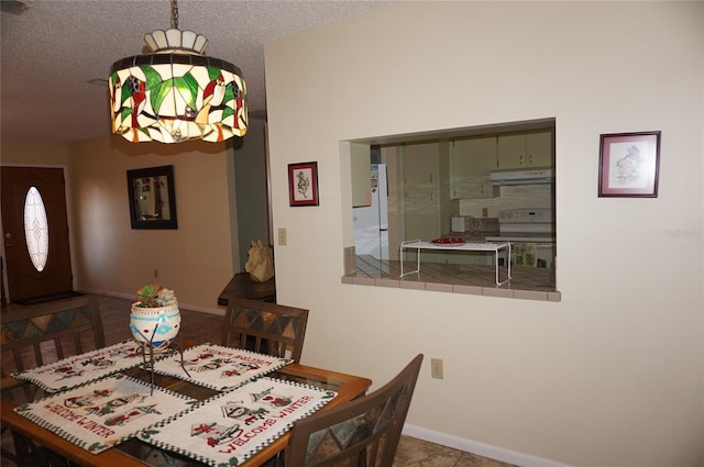 dining room featuring a textured ceiling