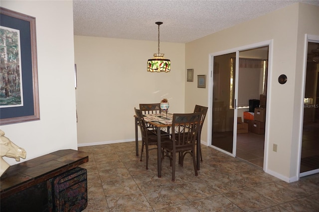 dining room featuring a textured ceiling