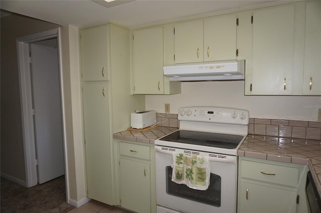 kitchen with tile countertops, dishwashing machine, white electric range, and tile patterned floors