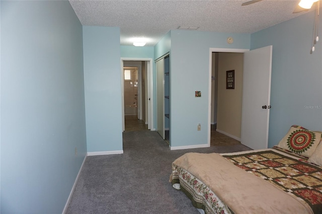 carpeted bedroom featuring ceiling fan, a textured ceiling, and a closet