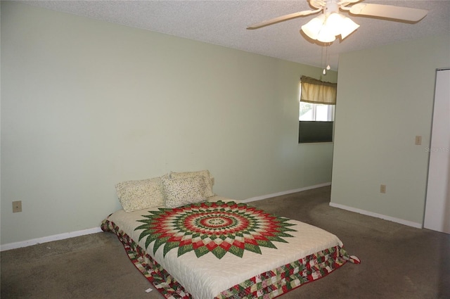 carpeted bedroom featuring ceiling fan and a textured ceiling