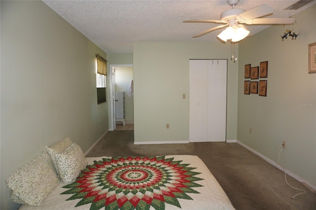 bedroom featuring a textured ceiling, dark carpet, and ceiling fan