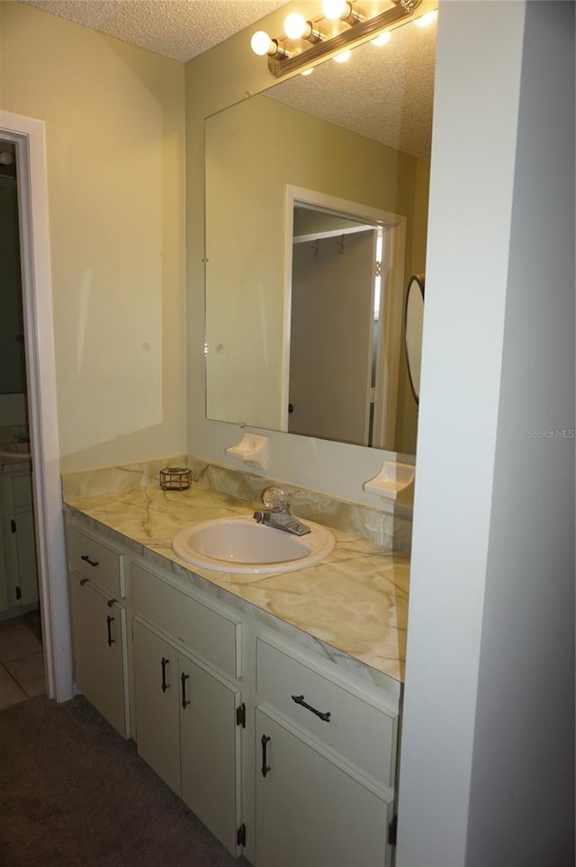 bathroom with vanity and a textured ceiling