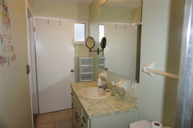 bathroom featuring tile patterned floors, vanity, and toilet