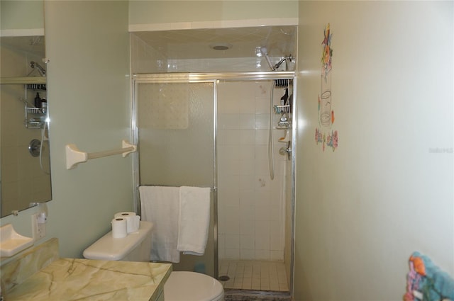 bathroom featuring walk in shower, vanity, and toilet